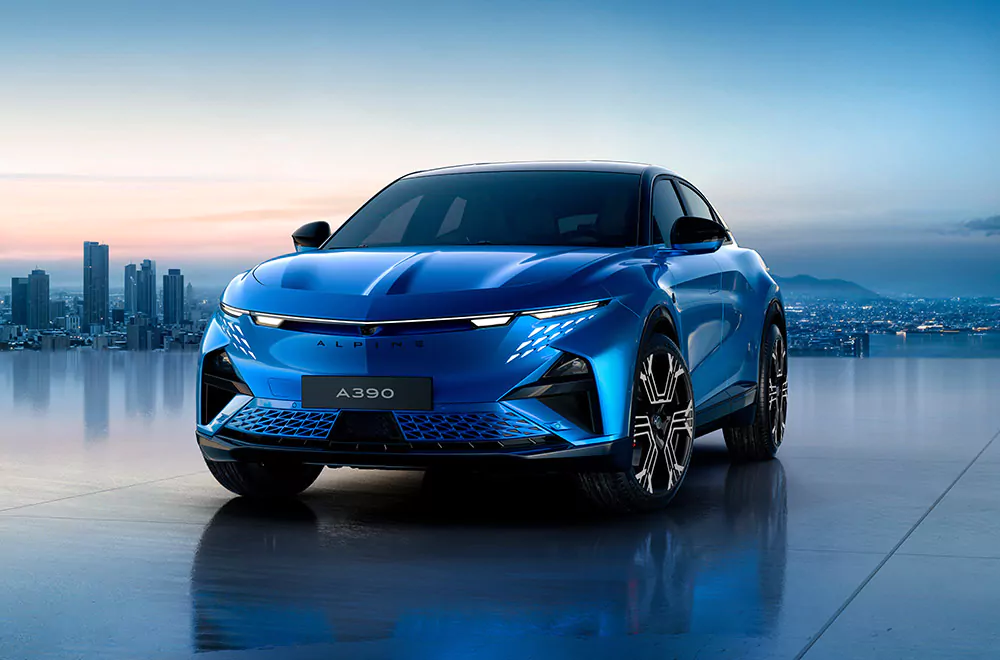 Ein elegantes blaues Elektroauto vom Typ Alpine A390 ist auf einer glänzenden Oberfläche geparkt, mit einer Stadtsilhouette und Bergen im Hintergrund in der Abenddämmerung und verkörpert den Geist der Alpine Minden Innovation.